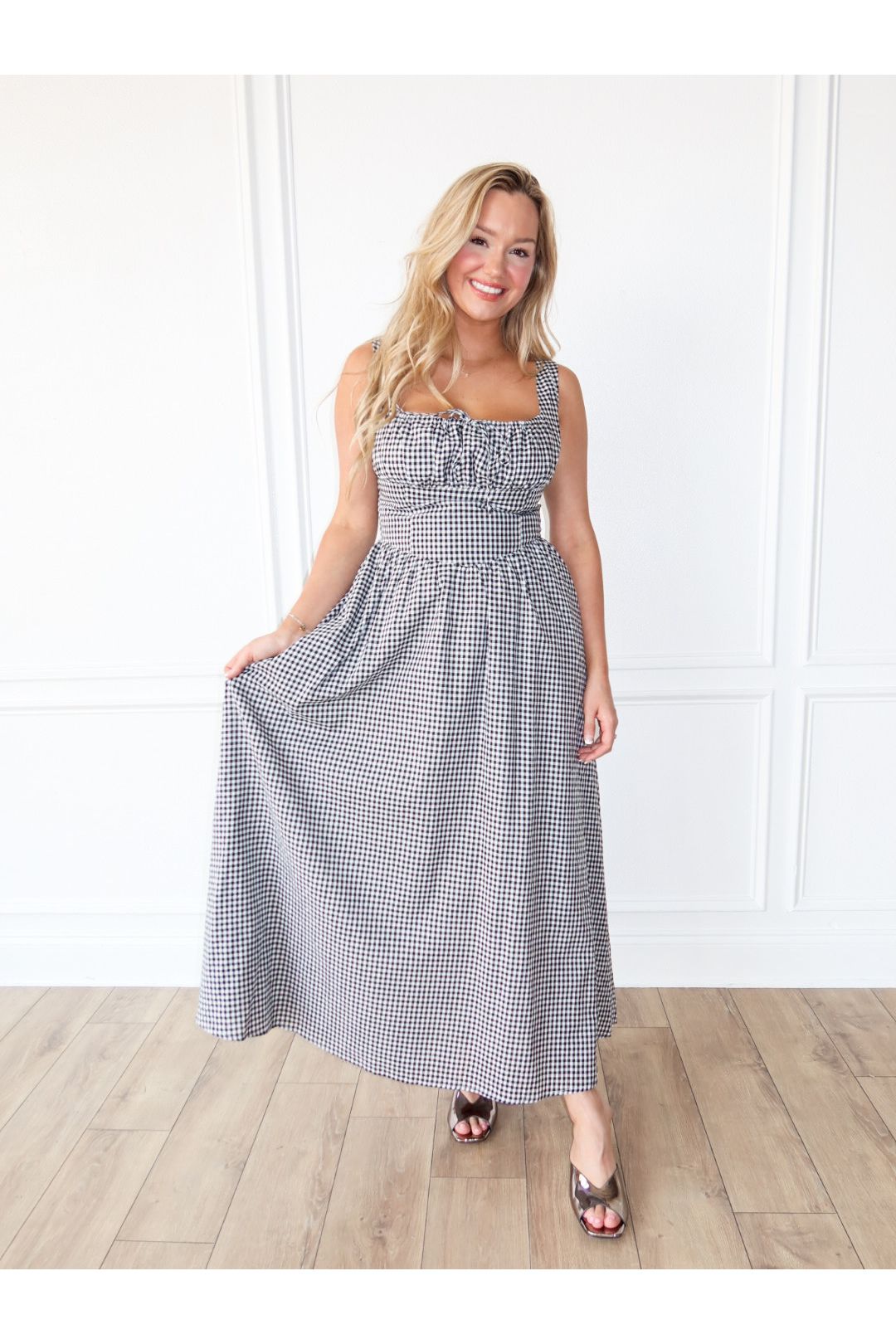 The Checkmate Corset Maxi Dress in white and black is a chic strapless maxi dress—perfect for weddings, formal events, date nights, and boutique fashion.