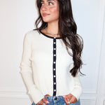 The Edge of Contrast Sweater in white with black trim is a chic women’s knit cardigan—perfect for layering, workwear, casual outfits, and boutique fashion.