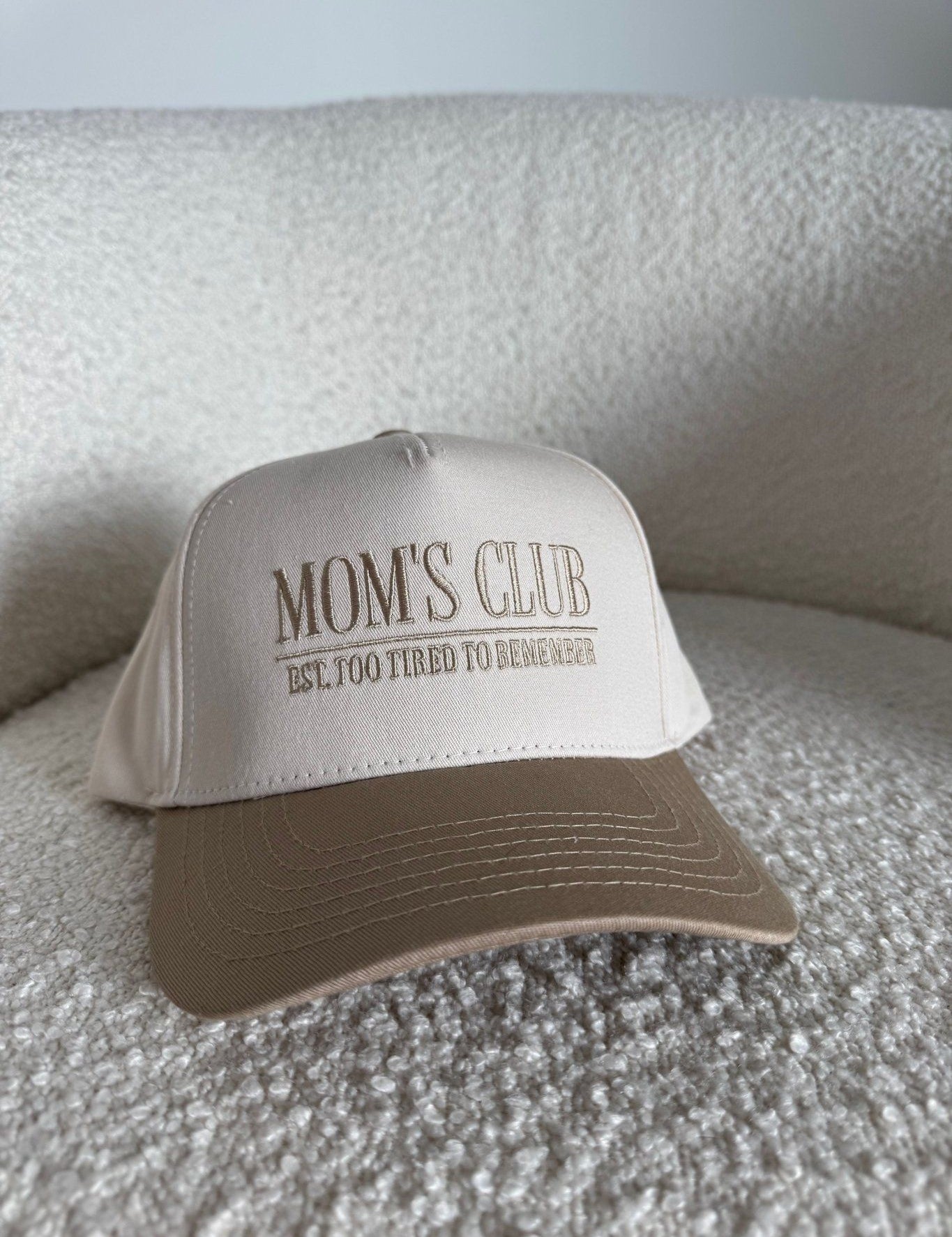 The Mom’s Club Trucker Hat is a stylish embroidered women’s trucker hat—perfect for casual outfits, everyday errands, and trendy boutique accessories.