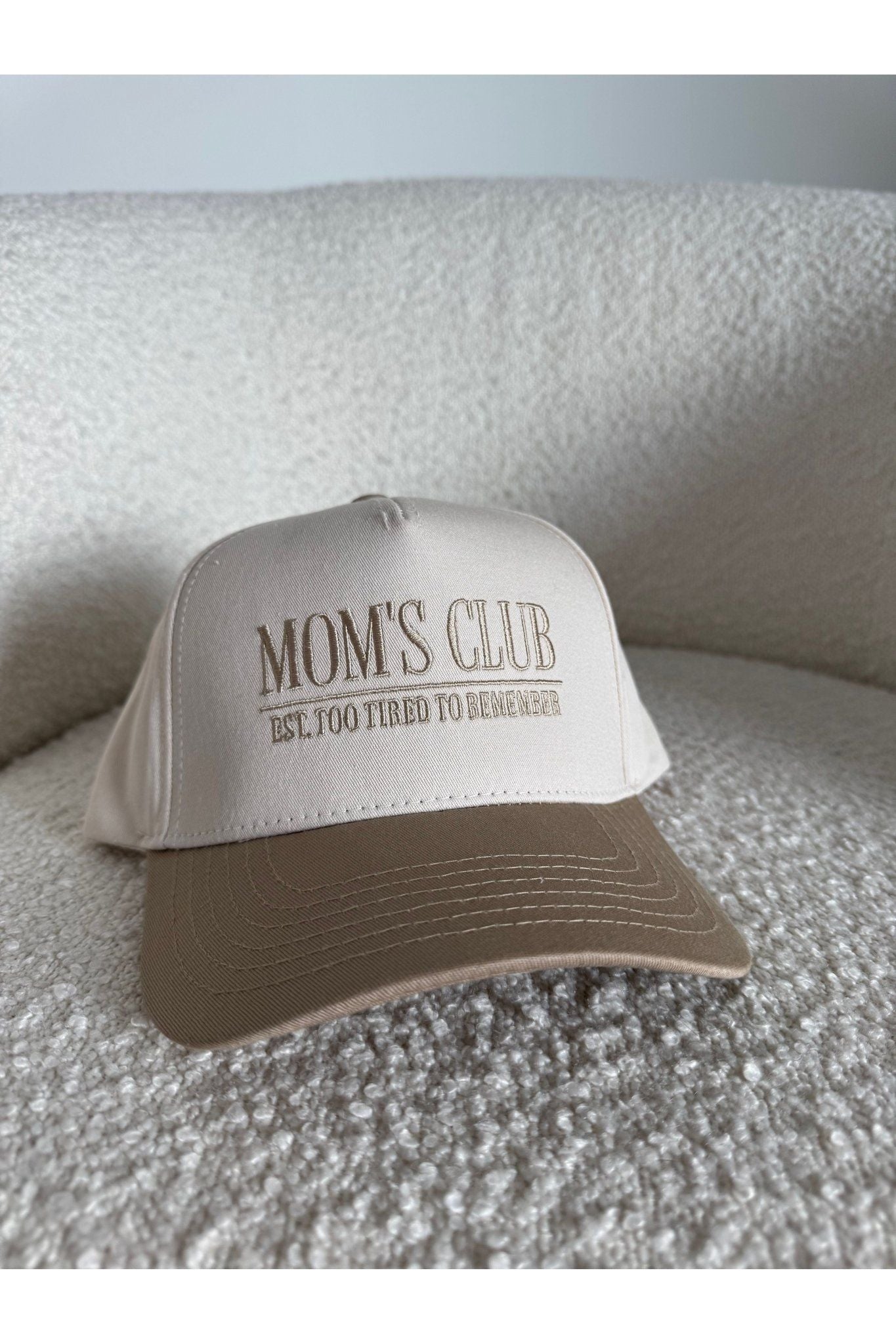 The Mom’s Club Trucker Hat is a stylish embroidered women’s trucker hat—perfect for casual outfits, everyday errands, and trendy boutique accessories.