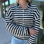 The Piper Cardigan is a viral lightweight women’s cardigan in black and white stripes—perfect for layering, fall outfits, and trendy boutique fashion.