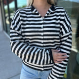 The Piper Cardigan is a viral lightweight women’s cardigan in black and white stripes—perfect for layering, fall outfits, and trendy boutique fashion.